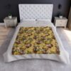 All over print blanket featuring capybara faces, lemons, and white flowers on a gold textured background. Perfect for animal lovers.
