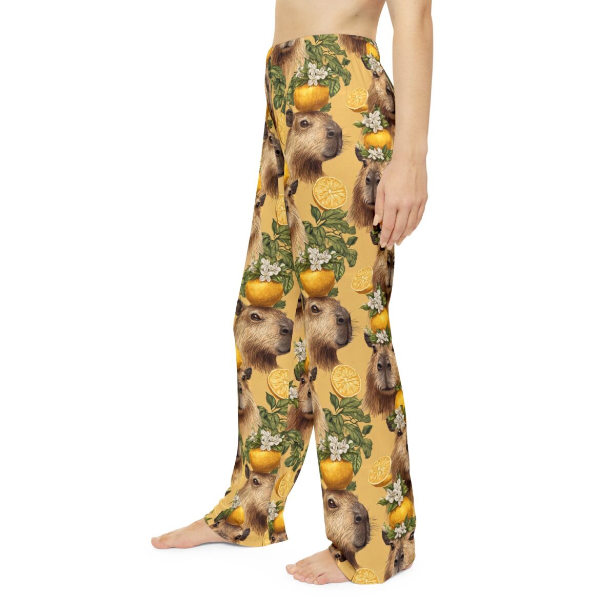 All over print pajama pants featuring a repeating pattern of capybara heads stacked with oranges and white blossoms. Seamless sublimation print.