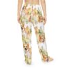 All over print pajama pants featuring a seamless repeat pattern of watercolor corgi dogs and green foliage.