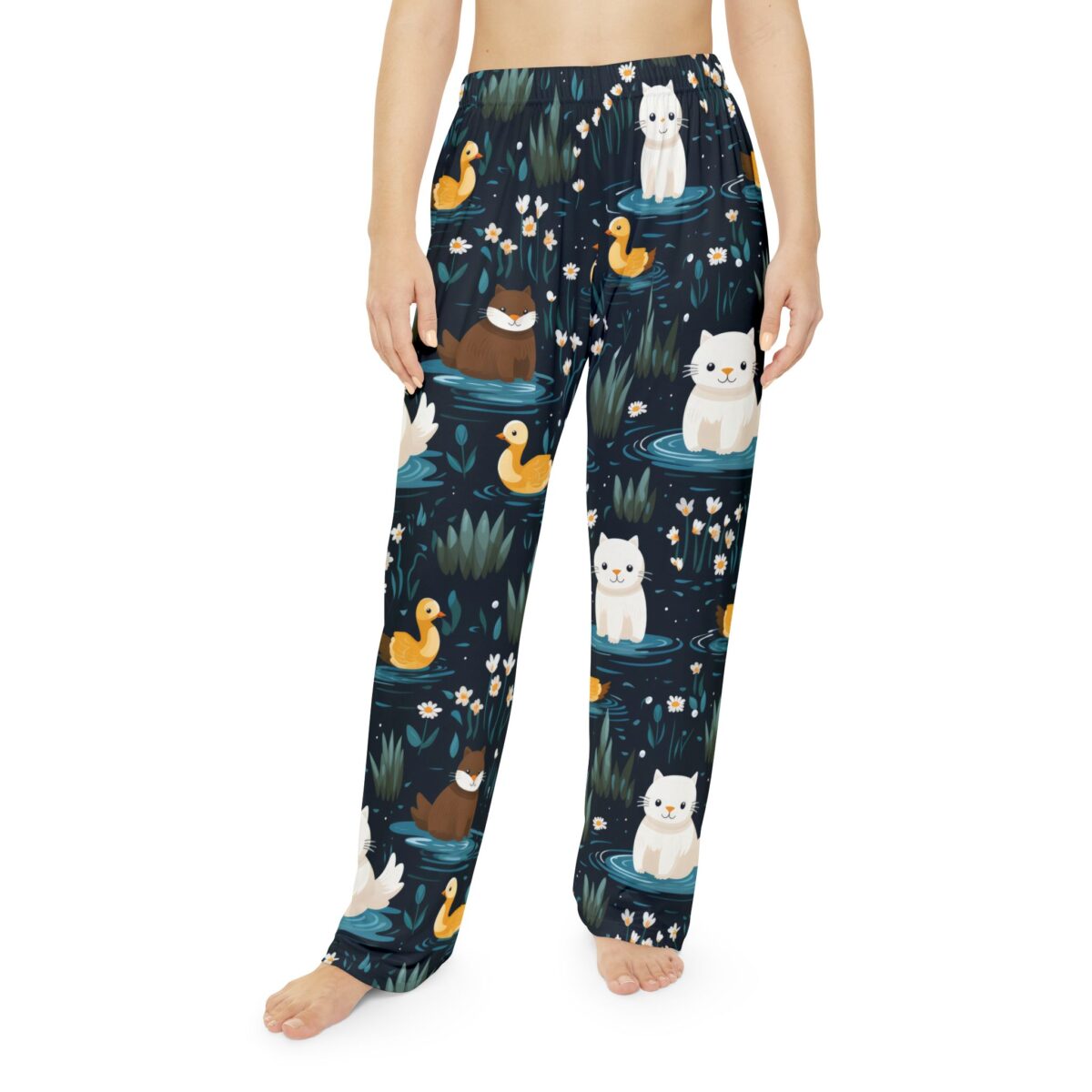 All over print pajama pants featuring white cats and yellow ducks on a dark pond with water lilies.