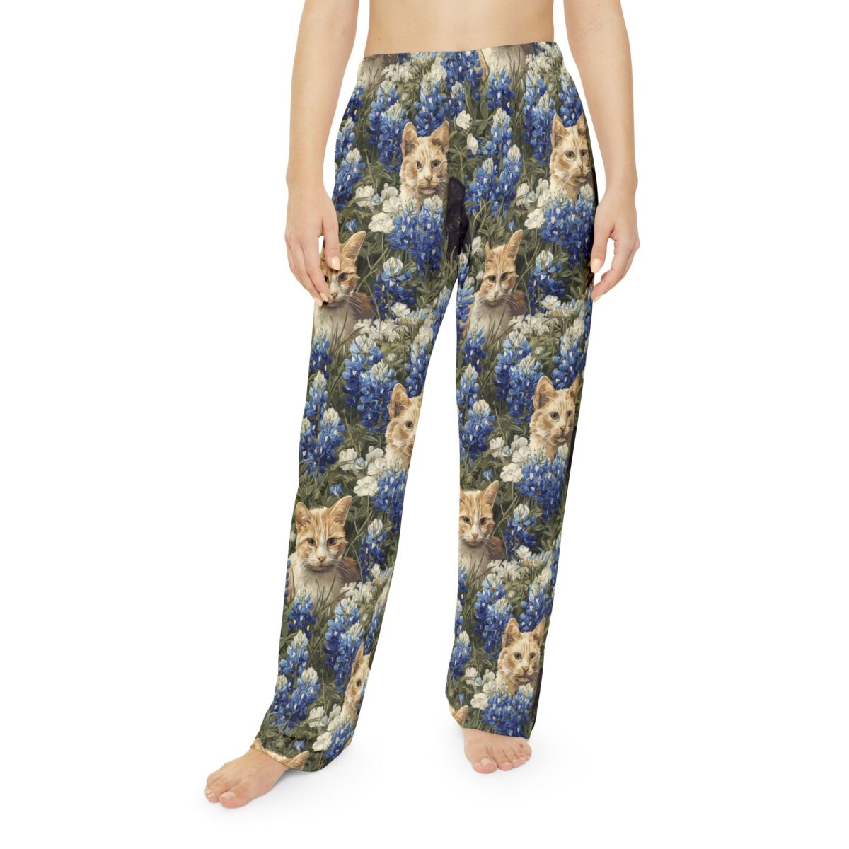 All over print pajama pants showcasing cute kittens nestled among bluebonnets and white wildflowers.
