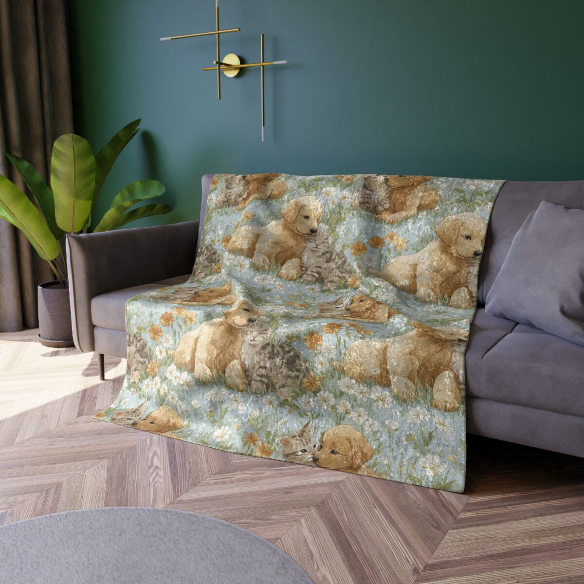 Soft golden retriever puppies and tabby kittens play amongst white daisies and orange flowers on a blue floral print blanket.