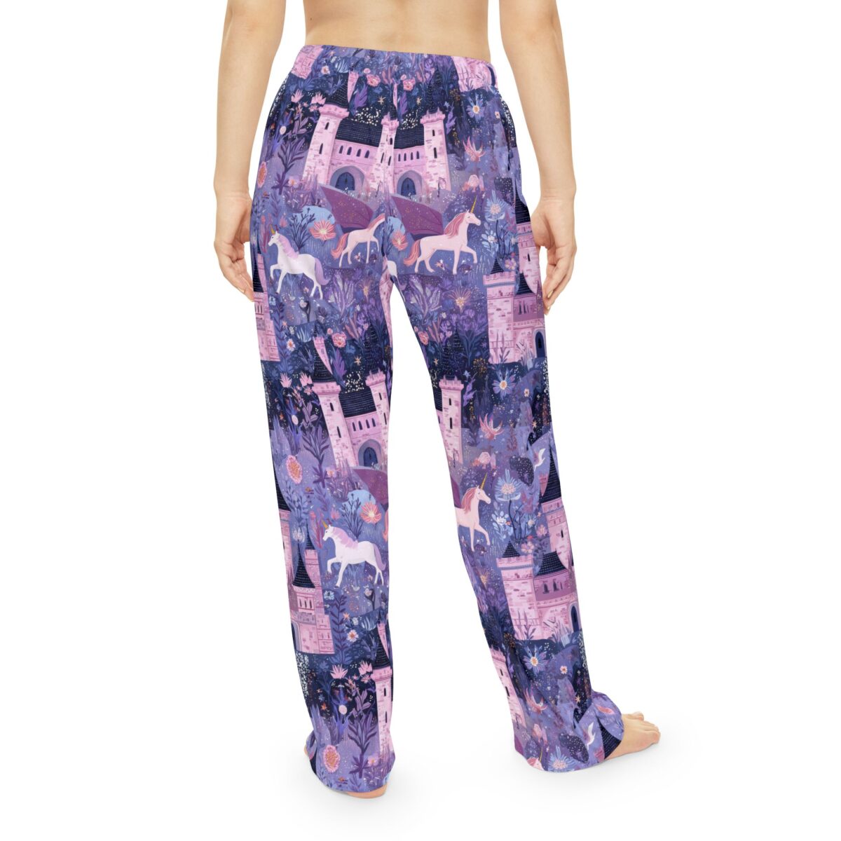 Purple pajama pants with all over print of fantasy castles, flying unicorns, and mystical floral motifs, seamless sublimation design.