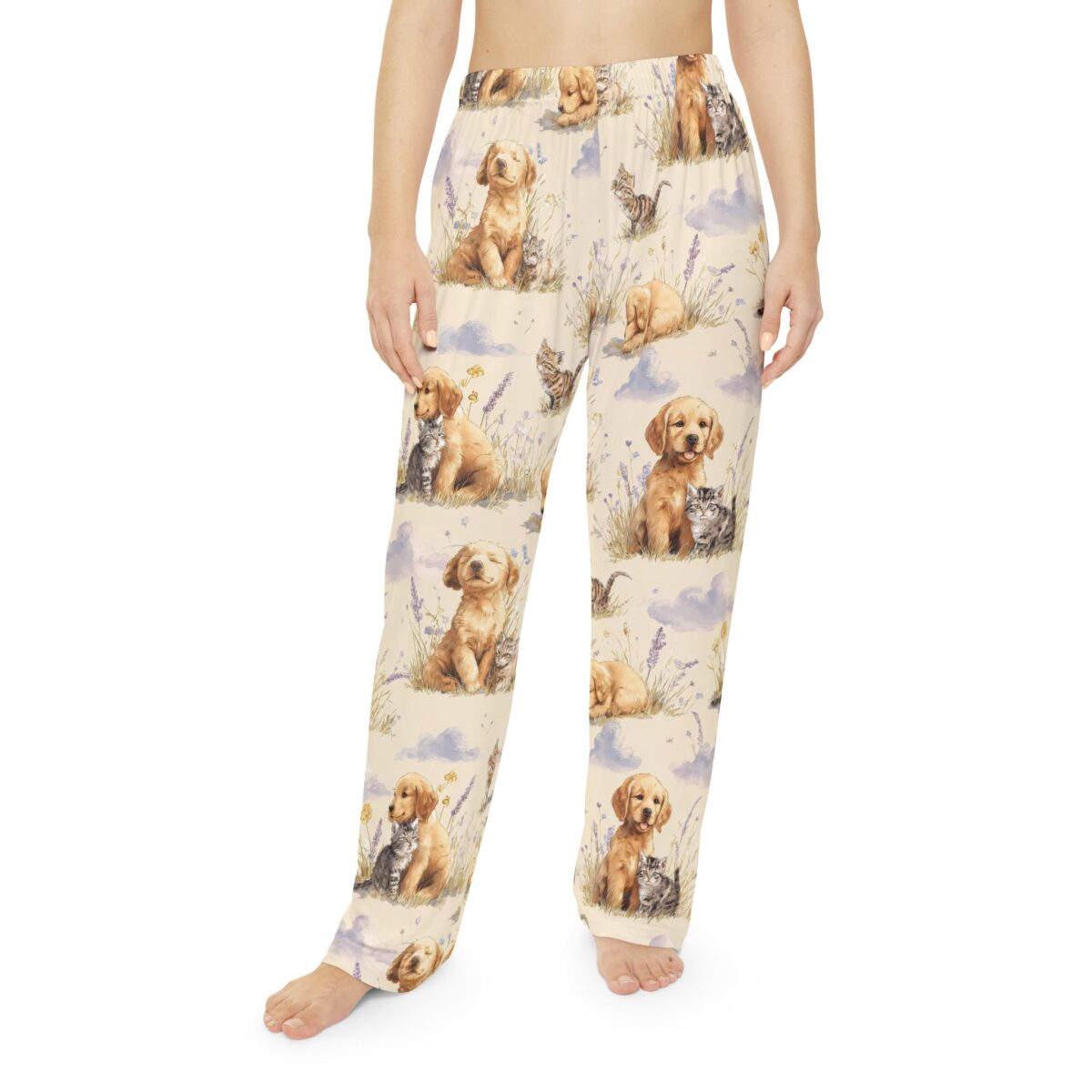 Cream pajama pants with an all over print of golden retriever puppies and kittens playing in lavender fields with clouds.