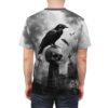 Gothic raven perched on a skull with bats and tombstones, all over print sublimation tee with dark graveyard graphic.