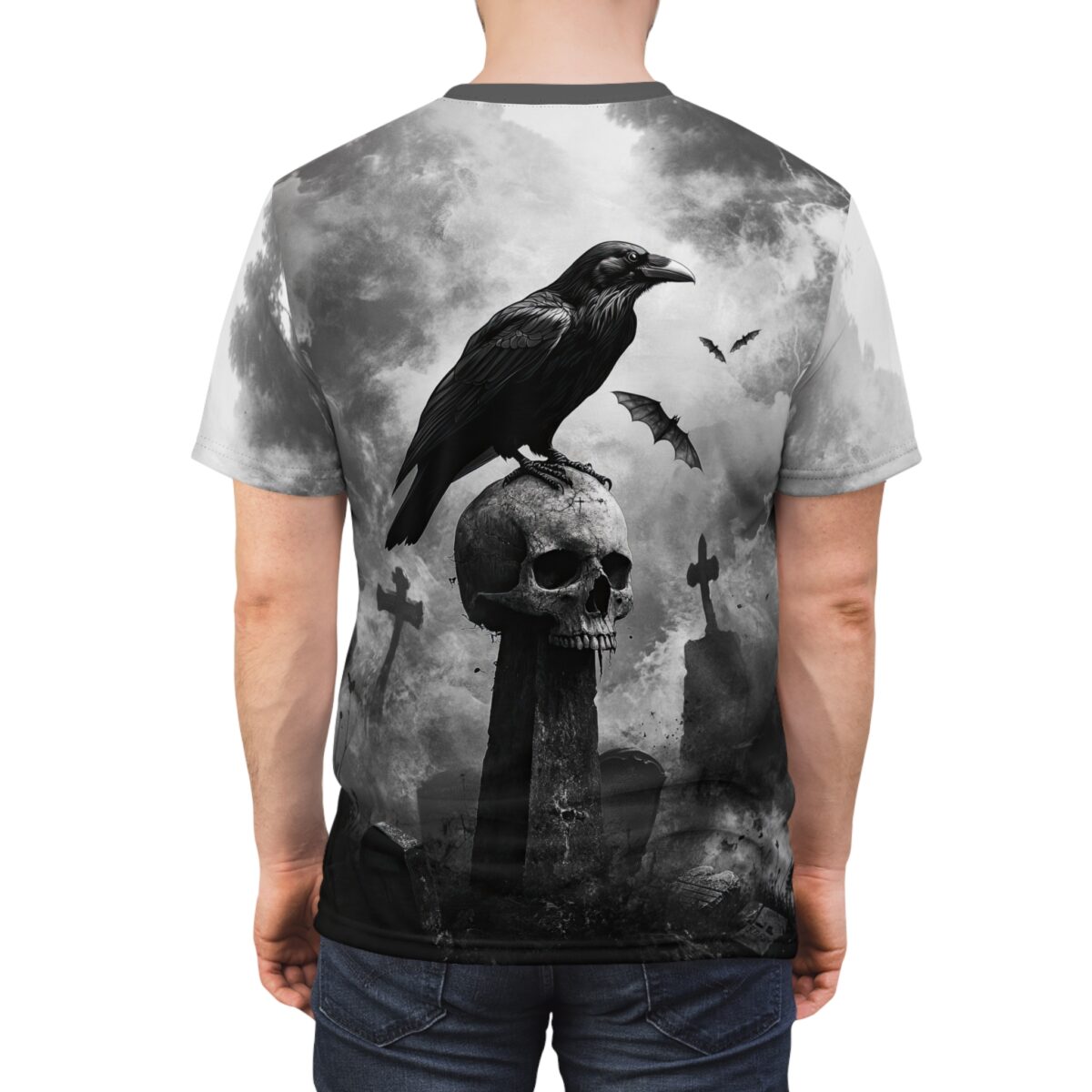 Gothic raven perched on a skull with bats and tombstones, all over print sublimation tee with dark graveyard graphic.