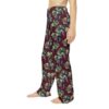 Burgundy pajama pants with a seamless all over print of green grape leaves and purple grapes.