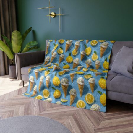 All over print fleece throw blanket with a repeating pattern of ice cream cones and yellow lemon slices on a blue background.