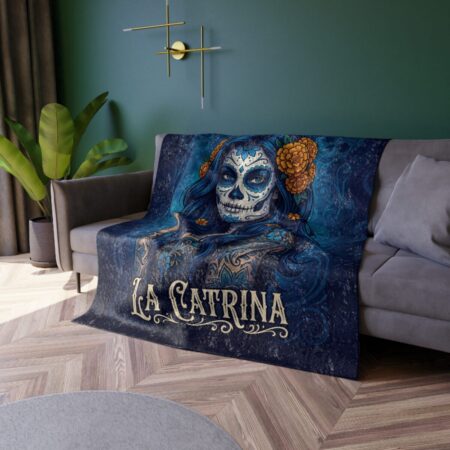 Dark blue blanket with a La Catrina sugar skull design featuring orange marigolds and intricate blue floral patterns.