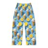 Seamless all over print pajama pants featuring ice cream cones and lemon slices on a blue background.
