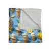 Blue blanket with all over print of lemon ice cream cones and sliced lemons.