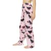 Pink pajama pants with a black bat, star, and ball graphic print all over.