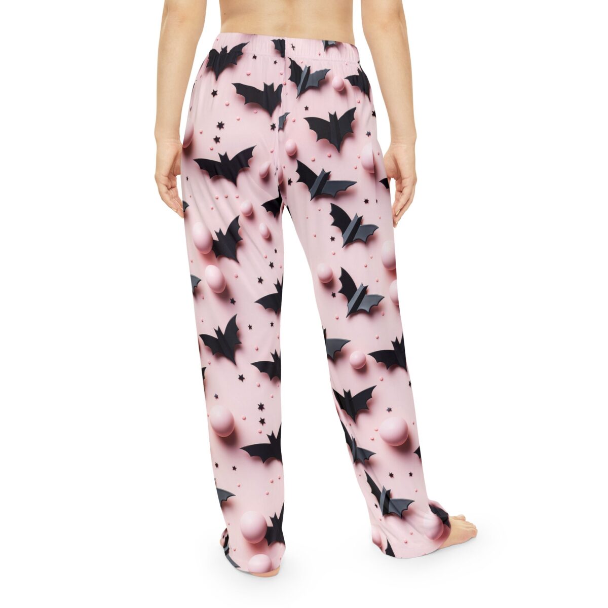 All over print pajama pants with black bats and pink spheres on a light pink background, featuring a seamless, retro repeat print design.