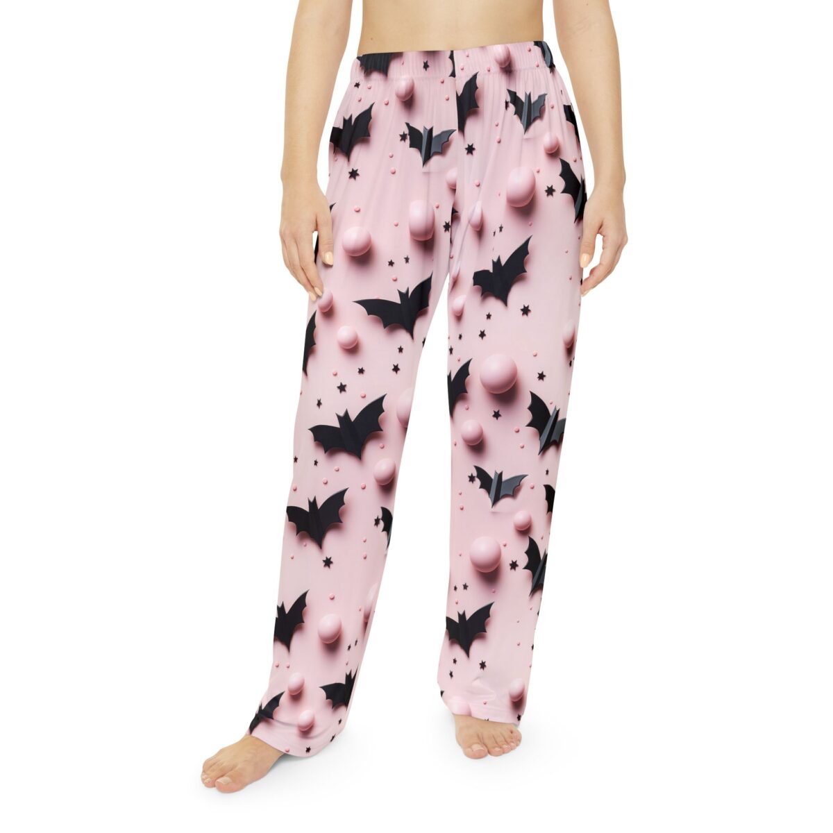 Pink all over print pajama pants featuring black bat and star graphics with pink spheres.