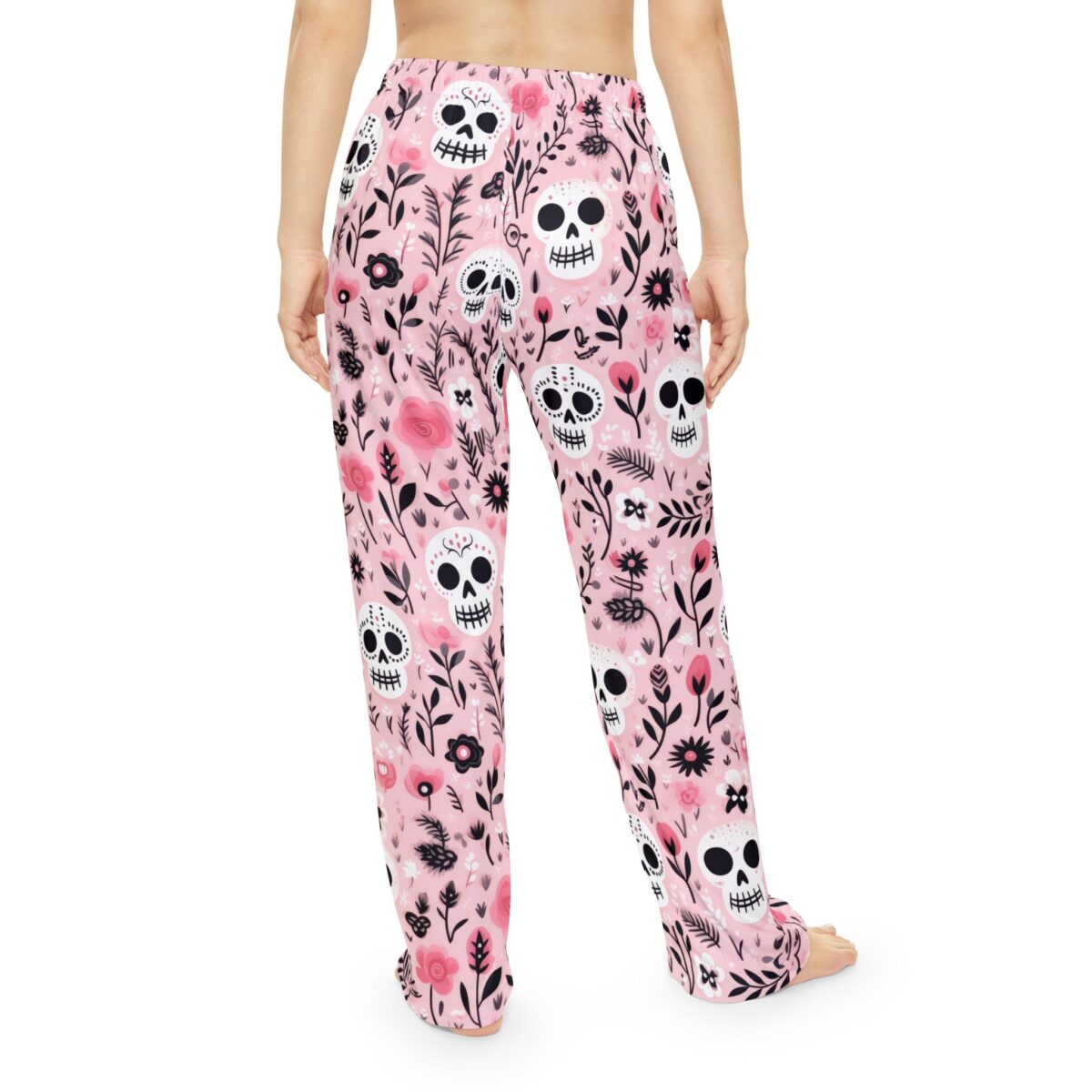 Pink pajama pants with an all-over print of sugar skulls and floral motifs. Seamless sublimation print design.