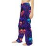 Cyber grunge all over print pajama pants, featuring a seamless wrap around graphic of neon skulls and spiders in a trippy festival aesthetic.