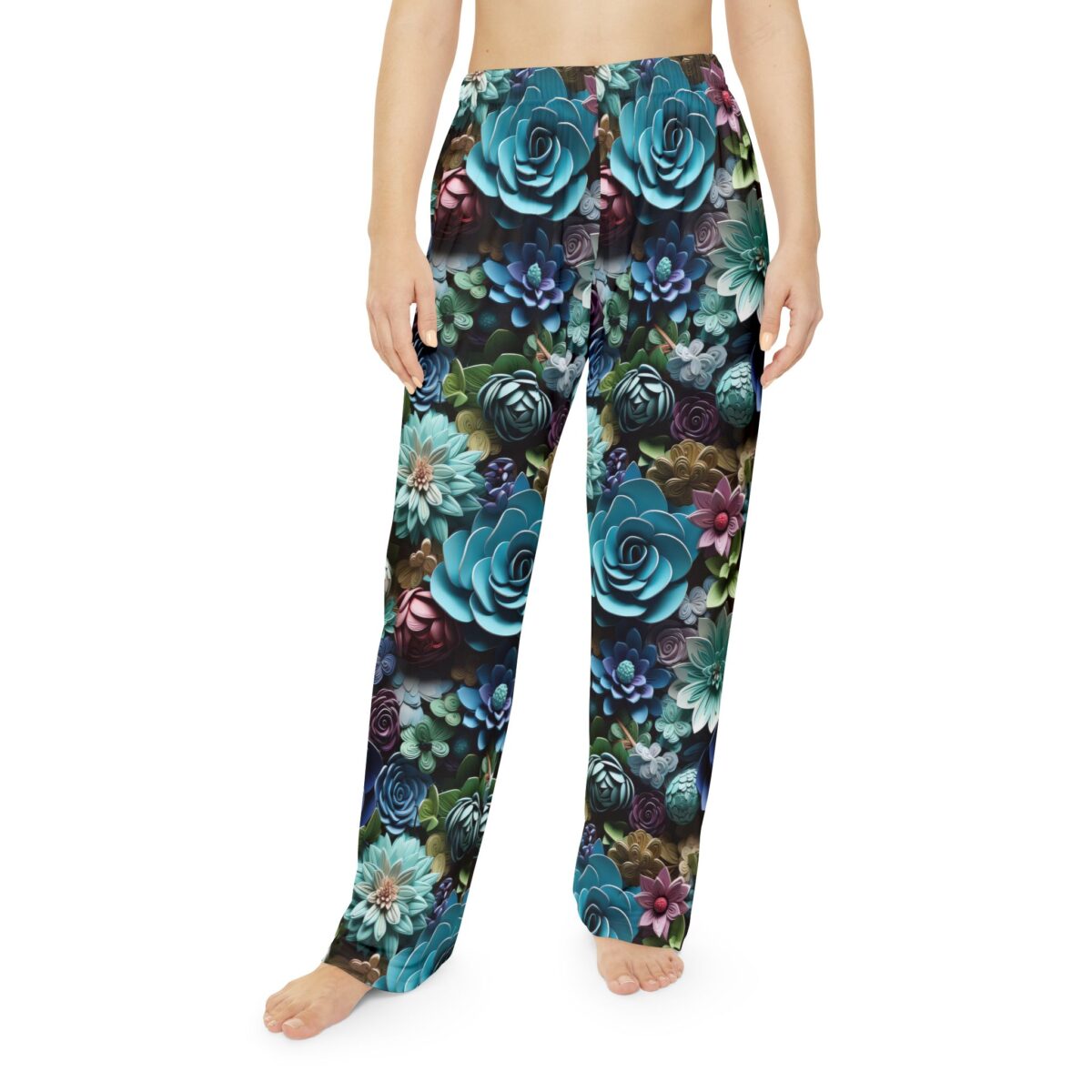 Close-up of pajama pants with a vibrant all-over print of blue, teal, and purple succulents and flowers.