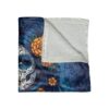 Fleece blanket featuring a colorful sugar skull woman with marigolds and swirling blue hair, evoking Day of the Dead art.