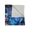 Sugar skull woman with blue floral accents and blue fire graphic on a cozy throw blanket.