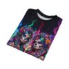 All over print women's sublimation tee featuring two vibrant sugar skull designs with colorful braids and fiery backgrounds.