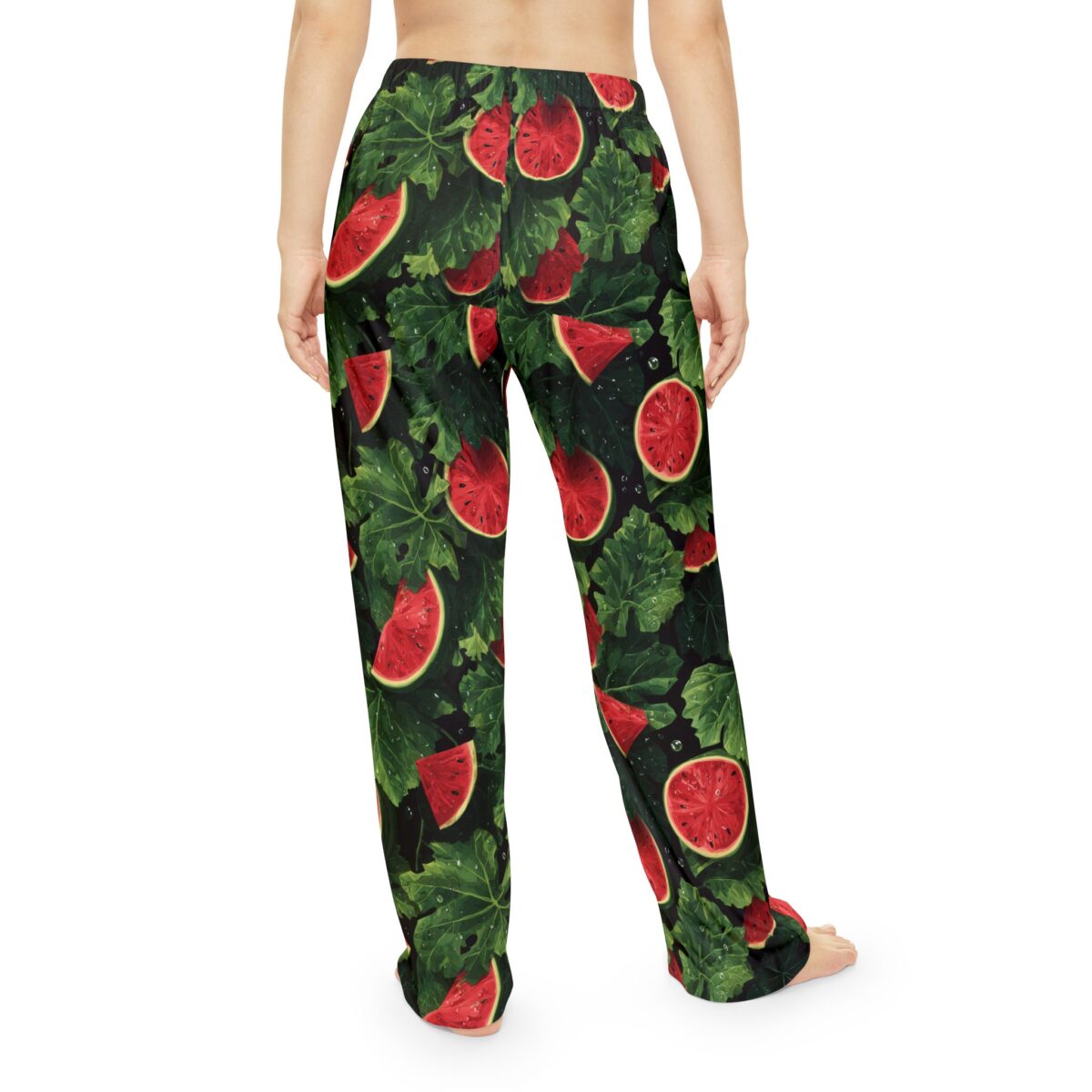 Pajama pants with a seamless all over print of vibrant red watermelon slices and lush green leaves, featuring water droplets.