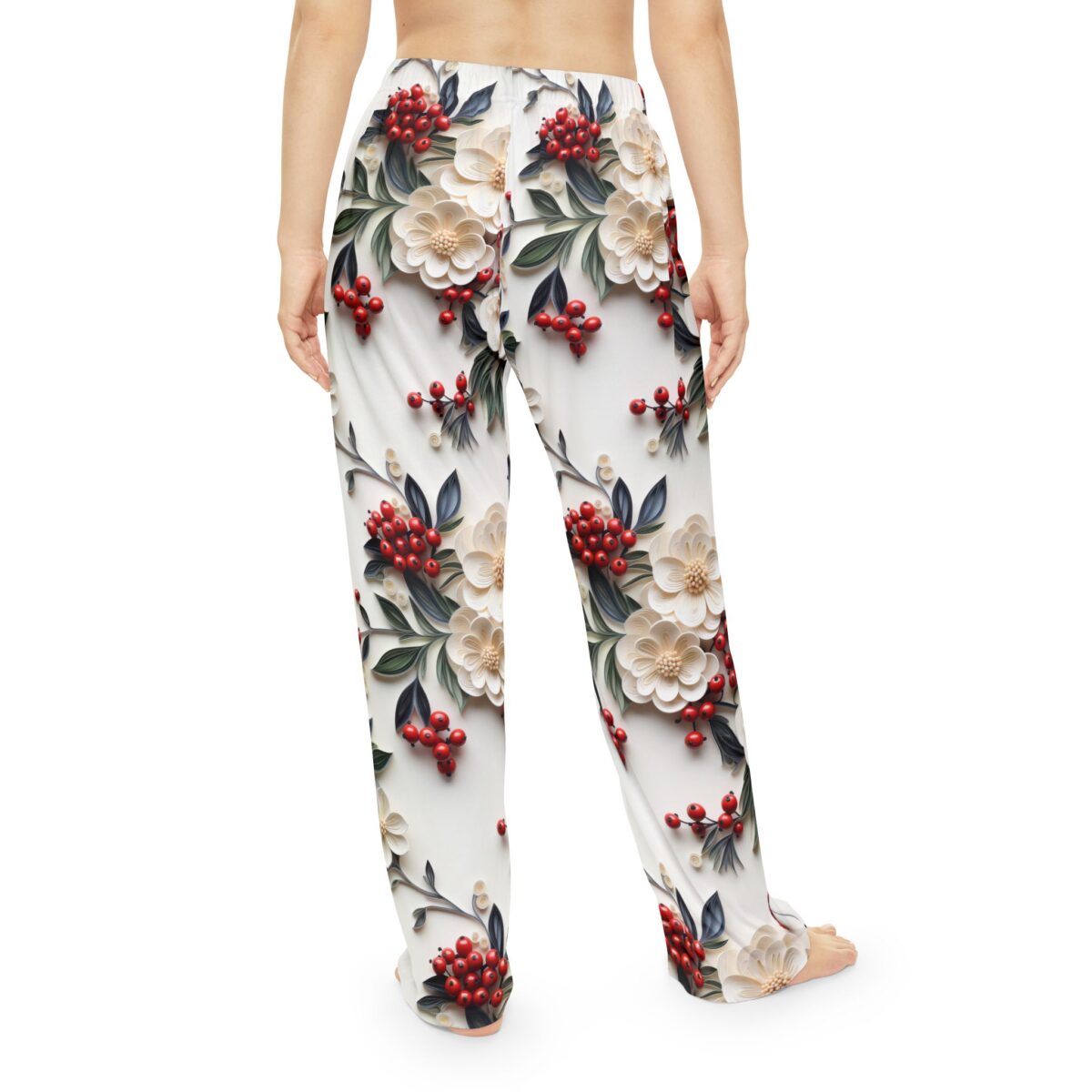 White pajama pants with a detailed all-over print of cream flowers, red berries, and dark green leaves.