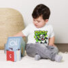 White kid's graphic tee featuring a cartoon panda with a spray paint can and green 