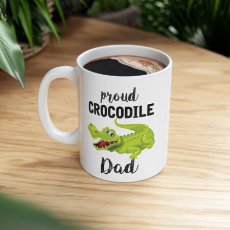 Proud Crocodile Dad ceramic coffee mug featuring a cartoon alligator graphic with text. Unique gift for fathers.
