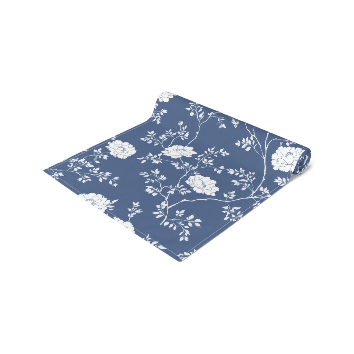 Blue runner featuring a white floral vine pattern. This decorative runner is perfect for tablescapes.