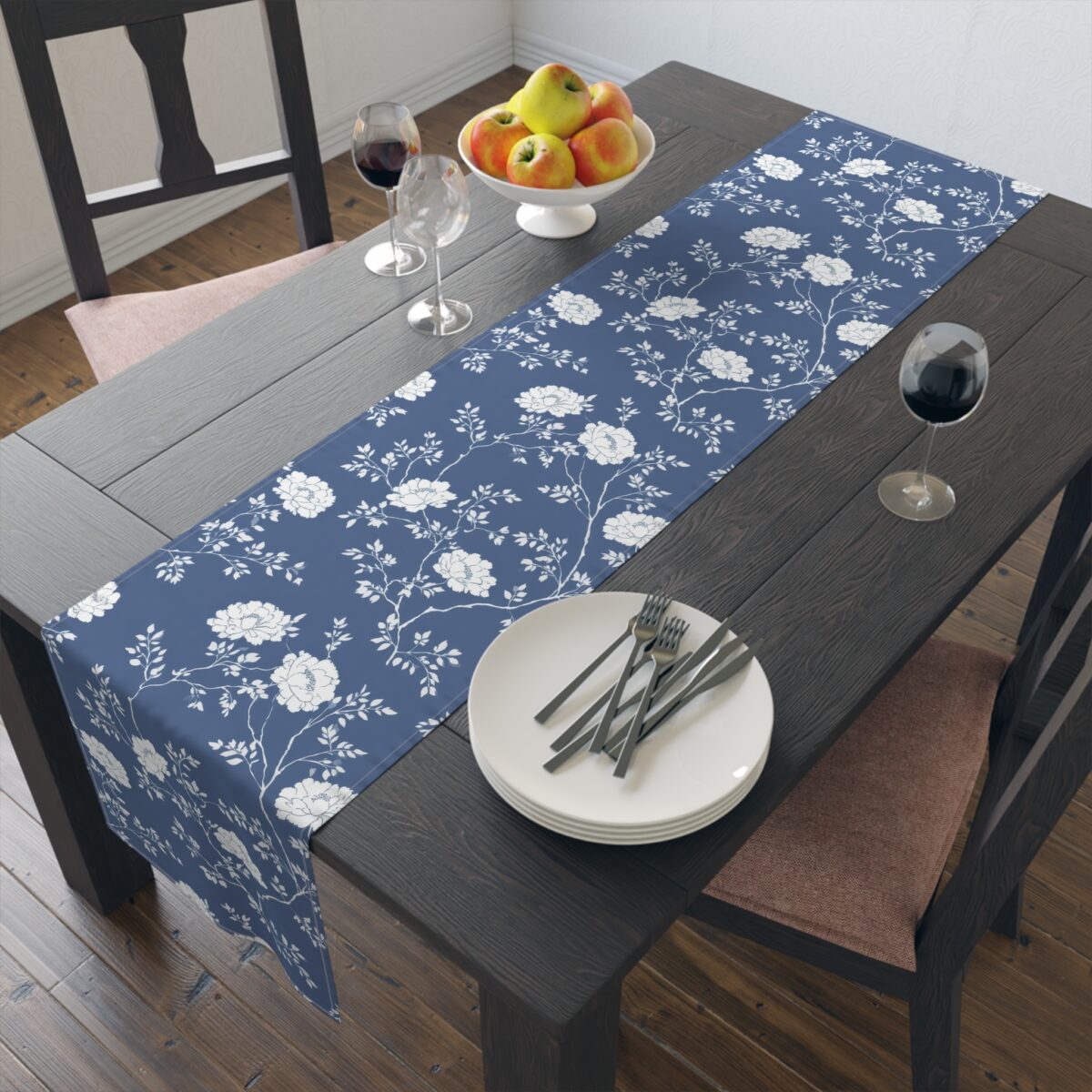 Blue table runner featuring a delicate white floral vine pattern, perfect for dining room decor.