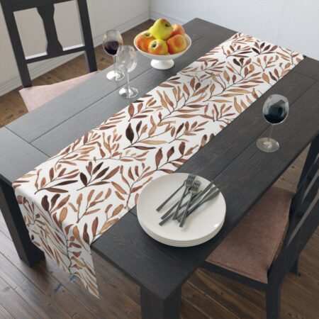 Table runner with a repeating watercolor brown leaf pattern on a white background, ideal for autumn dining and rustic home decor.