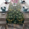 Dark green table runner featuring a vintage holly leaf and berry pattern with gold accents.