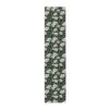 Black runner rug with repeating white daisy floral print and green leaves, seamless pattern design.