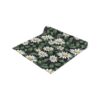 Black table runner with a vintage floral daisy print and green leaves.