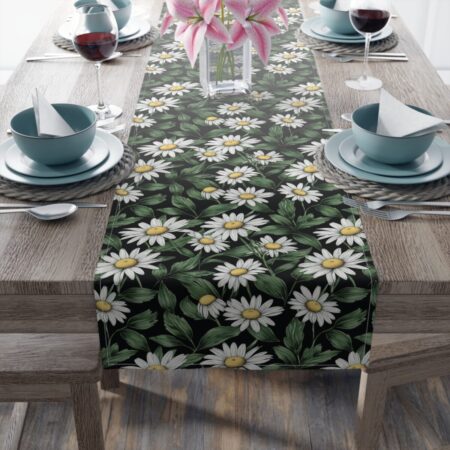 Black table runner featuring a repeating white daisy floral pattern with green leaves and yellow centers, botanical print.
