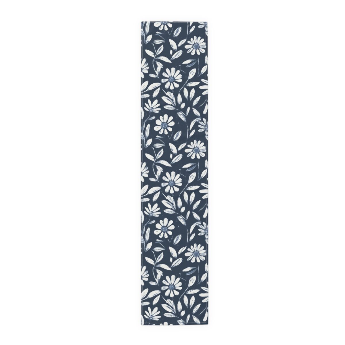 Navy blue table runner featuring a white daisy floral and leaf pattern all over.