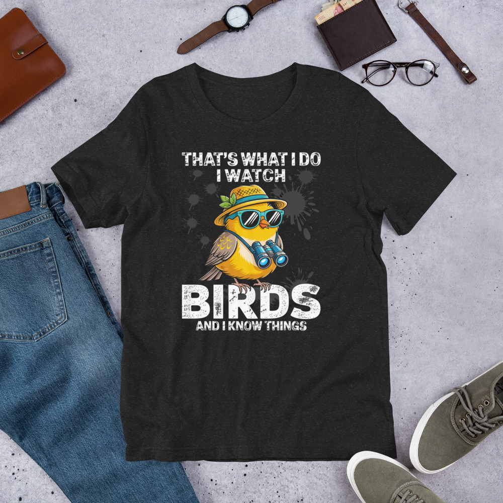 Graphic t-shirt with a cartoon yellow bird wearing sunglasses and a hat, holding binoculars, with text that says "That's What I Do, I Watch Birds And I Know Things."