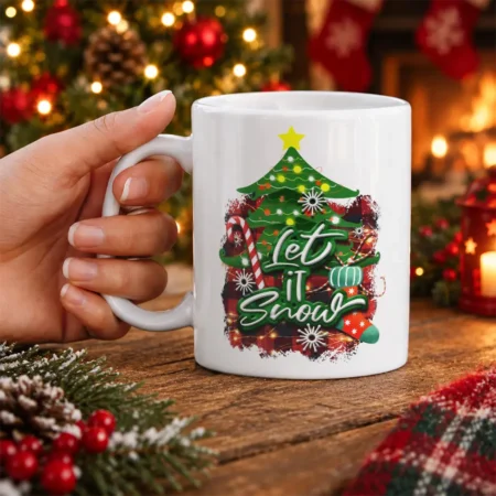 White ceramic mug displaying a Let it Snow Christmas tree graphic with buffalo plaid background and festive ornaments.