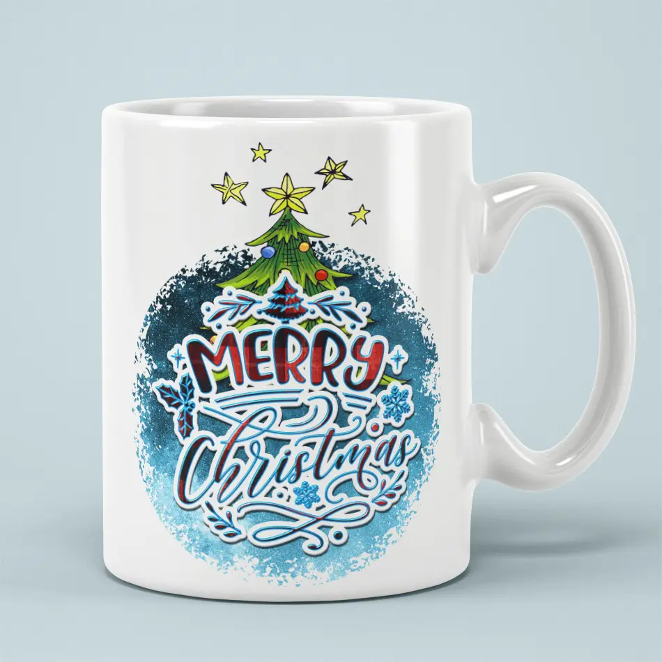 White ceramic coffee mug featuring Merry Christmas lettering with a decorated Christmas tree and blue splatter background.