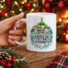 White ceramic mug featuring a festive Christmas tree graphic with My Quarantine Christmas text inside a sparkling ornament emblem.