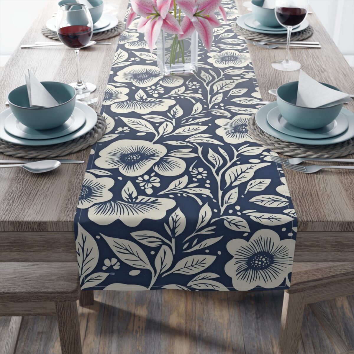 Navy blue table runner with a cream floral and leaf pattern, perfect for a farmhouse or vintage kitchen table setting.