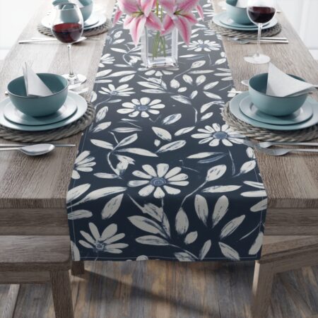 Navy blue table runner with a white daisy floral and leaf pattern, perfect for accent decor.