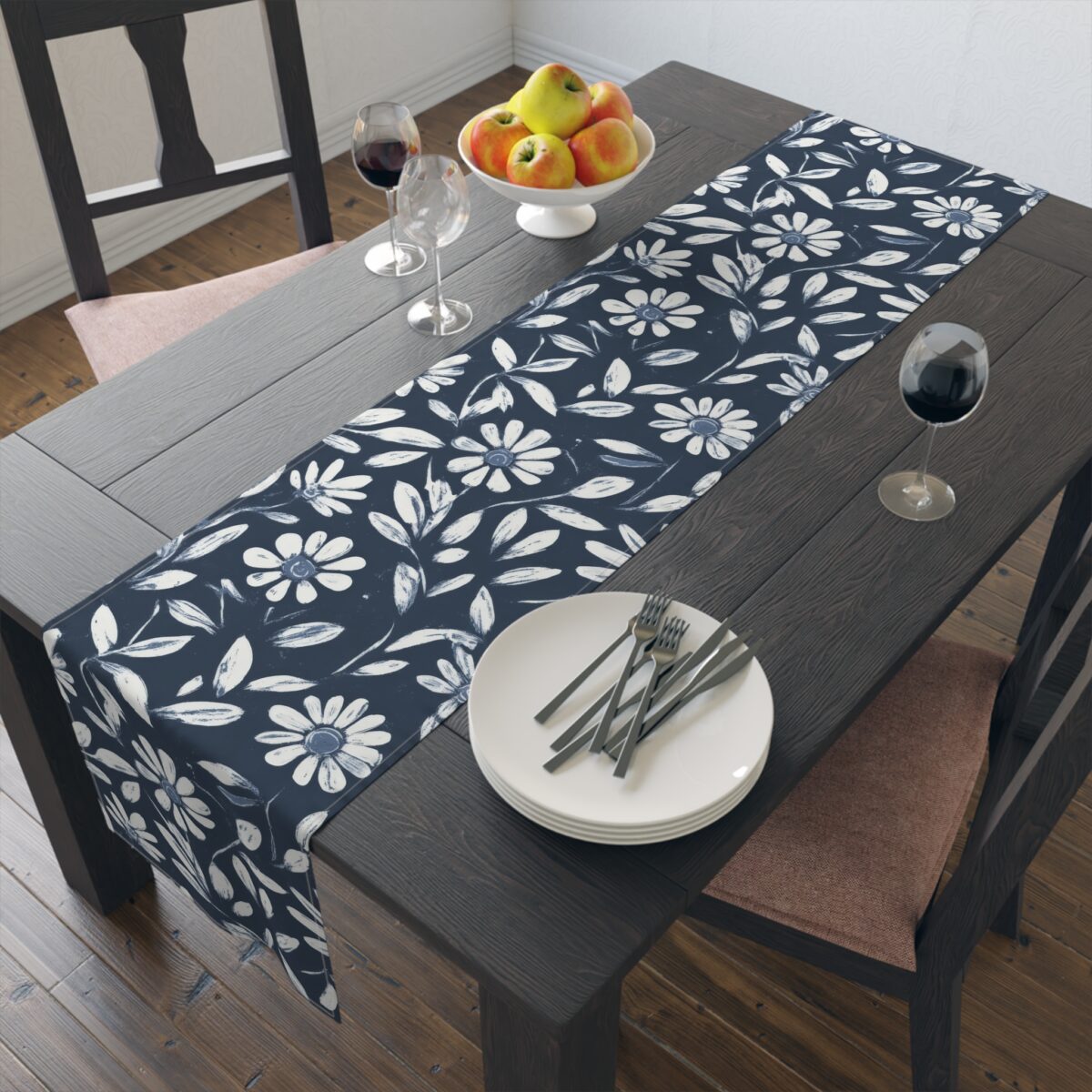 Navy blue table runner featuring a white daisy floral and leaf pattern. A farmhouse decorative accent for dining tables.