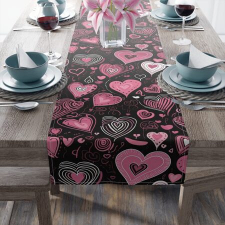 Pink hearts and doodles on a black all-over print table runner, perfect for Valentine's Day decor or romantic settings.