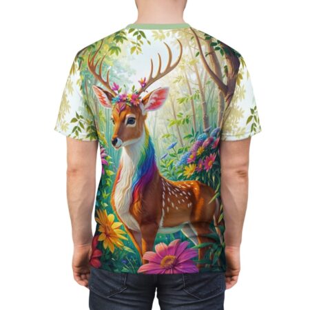 All over print sublimation tee featuring a mystical rainbow-maned deer with a floral crown standing in a vibrant enchanted forest with colorful flowers and dappled sunlight.