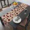 Cream table runner featuring a repeating pattern of red poppies and golden wheat stalks. Perfect for fall decor.