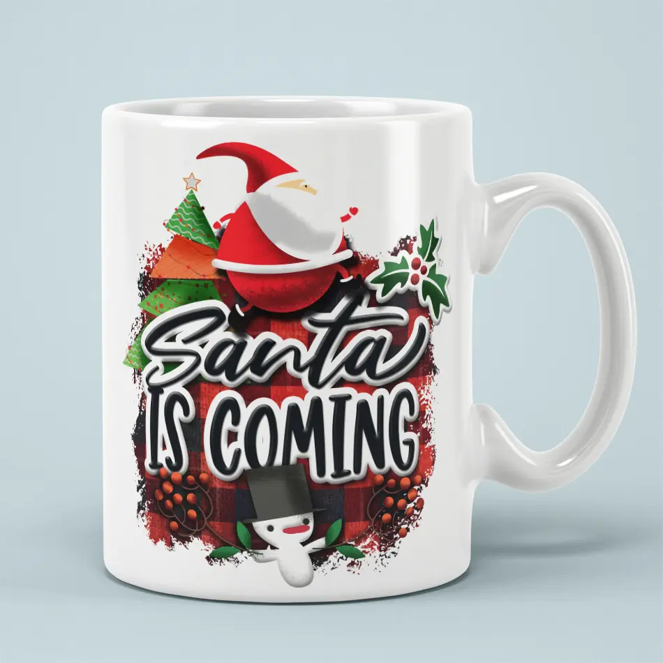 White ceramic coffee mug with Santa Is Coming text over red buffalo plaid, Christmas tree, and snowman artwork.