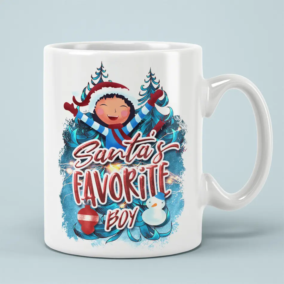 White ceramic mug printed with Santas Favorite Boy Christmas lettering, a smiling boy wearing a hat, pine trees, and snowman.