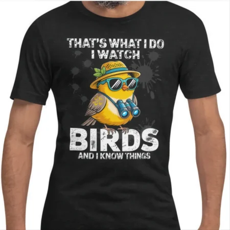 Funny yellow bird in sunglasses holding binoculars on a black graphic t-shirt with distressed text.
